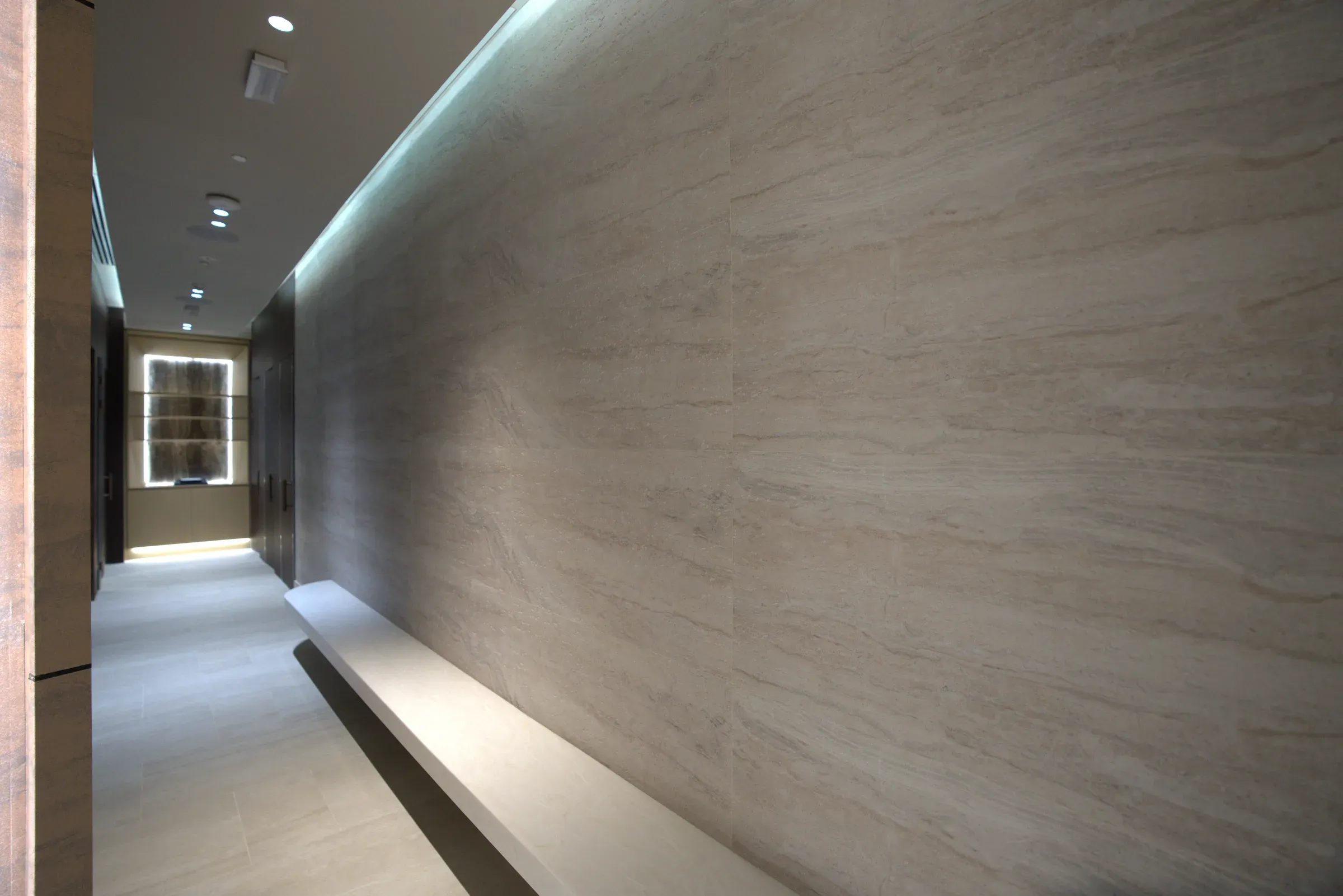 Lit MCM travertine corridor wall