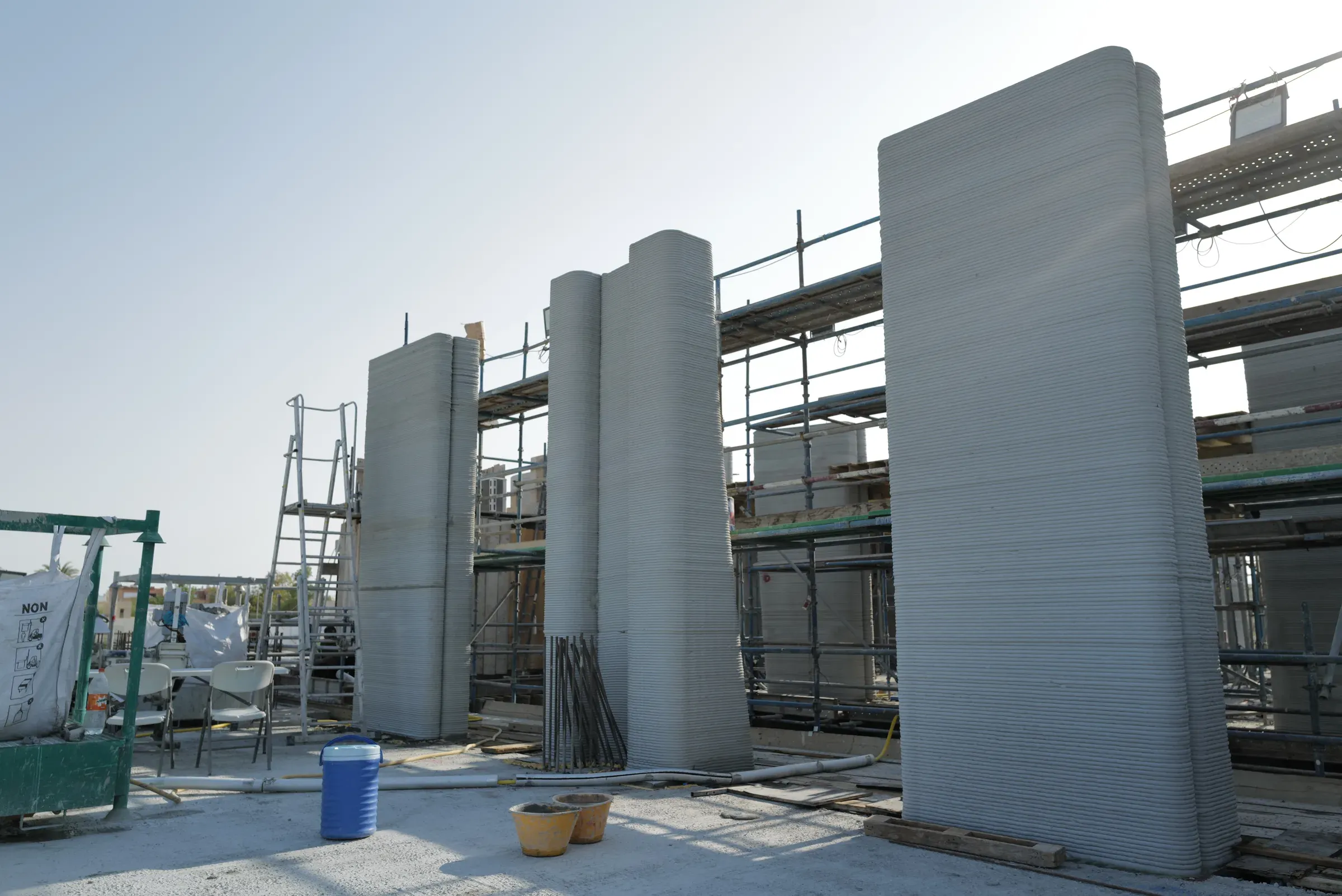 Printed walls rising in scaffolding